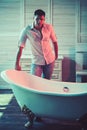 Healthy man in bathroom, health concept. Healthy macho in shirt and jeans ready to bath