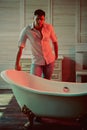 Healthy man in bathroom, health concept. Healthy macho in shirt and jeans ready to bath