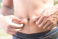 Healthy man measuring his body. Cropped and mid-section image of