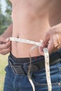 Healthy man measuring his body. Cropped and mid-section image of