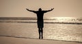 healthy man silhouette raised hands on beach. energetic summer. feel freedom.