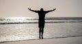 healthy man silhouette raised hands on beach. energetic summer. feel freedom.