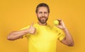 healthy man with vitamin fruit isolated on yellow, thumb up. healthy man with vitamin fruit
