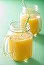 Healthy mango pineapple smoothie in mason jars