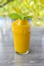 Healthy Mango smoothie frappe in a glass on wood table