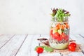 Healthy mason jar salad with vegetables and quinoa, table scene on bright background Royalty Free Stock Photo