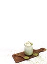 Healthy matcha dessert with aquafaba and mint. Glass jar on light background with copy space