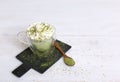 Healthy matcha dessert with aquafaba and mint. Glass jar on light background with copy space