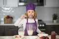 Healthy meal and dinner preparation. Chef child cook baking on the kitchen, lick spoon . Royalty Free Stock Photo