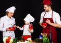 Healthy meal and dinner preparation. Happy family preparing breakfast together. Parents teaching little boy to cook Royalty Free Stock Photo