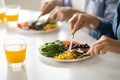 Healthy Meal. Man And Woman Eating Tasty Food In Kitchen, Closeup Royalty Free Stock Photo