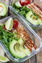 Healthy meal prep containers with rukola, turkey grill, tomatoes and avocado Royalty Free Stock Photo