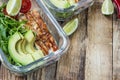 Healthy meal prep containers with rukola, turkey grill, tomatoes and avocado Royalty Free Stock Photo