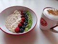 Healthy granola with fruits and vanilla and almond milk on white background.