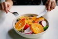 Healthy meals, diet recipes, A hand are using fork and knife to eat of mixed salad with preserved salmon on white plate and white Royalty Free Stock Photo