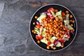 Healthy Mediterranean salad with chick peas over a dark background Royalty Free Stock Photo