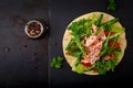 Healthy mexican corn tacos with baked salmon, lettuce, tomato, cucumber and arugula.