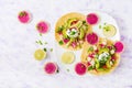 Healthy mexican corn tacos with boiled chicken breast, avocado and watermelon radish and yogurt dressing.