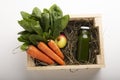 Healthy mix of fresh carrots and apples with spinat in wooden box