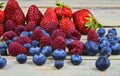 Healthy mixed fruit and ingredients with strawberry, raspberry, blueberry. Berries on rustic white wooden background Royalty Free Stock Photo