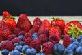 Healthy mixed fruit and ingredients with strawberry, raspberry, blueberry. Berries on rustic white wooden background Royalty Free Stock Photo