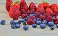 Healthy mixed fruit and ingredients with strawberry, raspberry, blueberry. Berries on rustic white wooden background Royalty Free Stock Photo