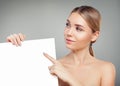 Healthy model woman pointing and holding empty white card singboard Royalty Free Stock Photo