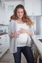 A healthy mom A healthy baby. 4k video footage of a pregnant woman drinking a glass of water at home. Royalty Free Stock Photo