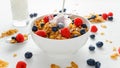 Healthy Morning Breakfast honey Corn flakes with fresh fruits of Raspberry, blueberries and pouring milk in bowl. Royalty Free Stock Photo