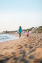 Healthy mother and baby girl running on beach Royalty Free Stock Photo