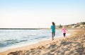 Healthy mother and baby girl running on beach Royalty Free Stock Photo