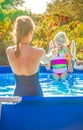 Healthy mother and child in swimsuit in swimming pool playing Royalty Free Stock Photo