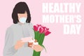 Healthy Mother`s day text and woman in face mask with greeting card and tulips bouquet on pink background. Healthy receiving gift Royalty Free Stock Photo