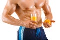 Healthy muscular man holding a glass with juice and orange, shaped abdominal, isolated Royalty Free Stock Photo