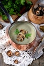 Healthy Mushroom cream soup with celery and parsley on an old wooden background. Rustic style. Royalty Free Stock Photo