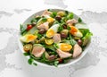 Healthy Nicoise salad with salmon, colourful sweet cherry tomatoes, olives, green beans, cucumber ribbons, soft boiled Royalty Free Stock Photo