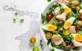 Healthy Nicoise salad with salmon, colourful sweet cherry tomatoes, olives, green beans, cucumber ribbons, soft boiled Royalty Free Stock Photo