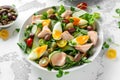 Healthy Nicoise salad with salmon, colourful sweet cherry tomatoes, olives, green beans, cucumber ribbons, soft boiled Royalty Free Stock Photo