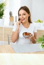 Healthy Nutrition. Beautiful Young Woman Eating Nuts Royalty Free Stock Photo