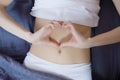 Healthy nutrition and belly health concept. Close up of woman flat stomach. Girl in bed with hungry feeling. Top view Royalty Free Stock Photo