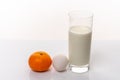 Healthy nutrition. Fresh mandarin, organic egg and a glass of milk isolated on white background Royalty Free Stock Photo