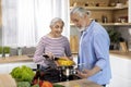 Healthy Nutrition. Happy Senior Couple Preparing Vegetable Meal Together In Kitchen Royalty Free Stock Photo