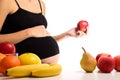Healthy nutrition and pregnancy. Pregnant woman and red apple Royalty Free Stock Photo