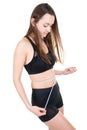 Healthy nutrition and weight losing concept young fit woman with slim body measuring her waistline and torso Royalty Free Stock Photo