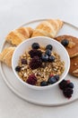 Healthy breakfast concept. Granola with berries and croissants. Royalty Free Stock Photo