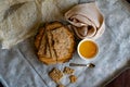 Healthy and nutritious diet bread with sesame and sunflower seeds on a thin crunchy malt base. Near natural bee honey and a wooden