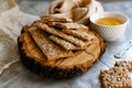 Healthy and nutritious diet bread with sesame and sunflower seeds on a thin crunchy malt base. Near natural bee honey and a wooden