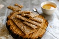 Healthy and nutritious diet bread with sesame and sunflower seeds on a thin crunchy malt base. Near natural bee honey and a wooden