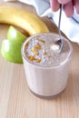 Healthy organic date, banana and apple milk smoothie powdered shredded coconut and orange zest. Fresh diet breakfast.