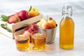 Healthy organic food. Apple cider vinegar or juice in glass bottle and fresh red apples.